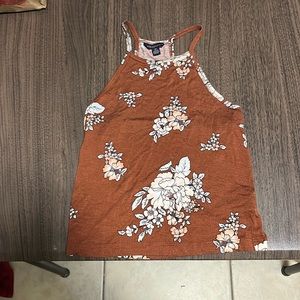 This is a cute crop top in good condition colors are brown, cream, pink